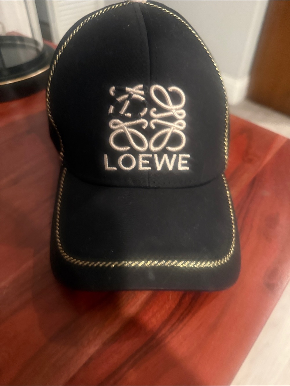 Black Cap with Gold Rope Stitching and White Logo